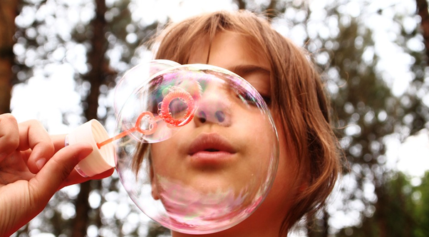 Child blowing a bubble.